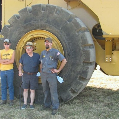 Lucas, Lee & Kent Herring in front of a coal pusher Kent rebuilt for his job.