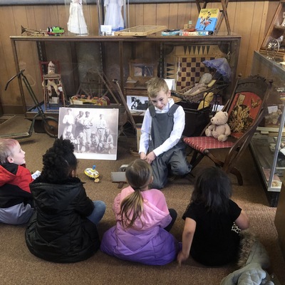 Elementary students learning about toys from the past.
